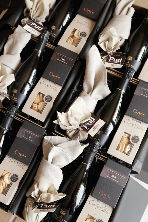Luxury style Sydney Hampers open to show Champagne and matching gourmet products all with sleek corporate style matching presentation
